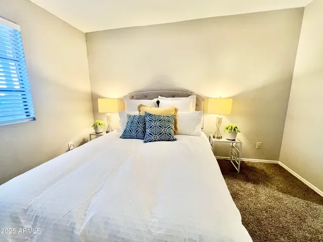 a bedroom with a bed and lamps