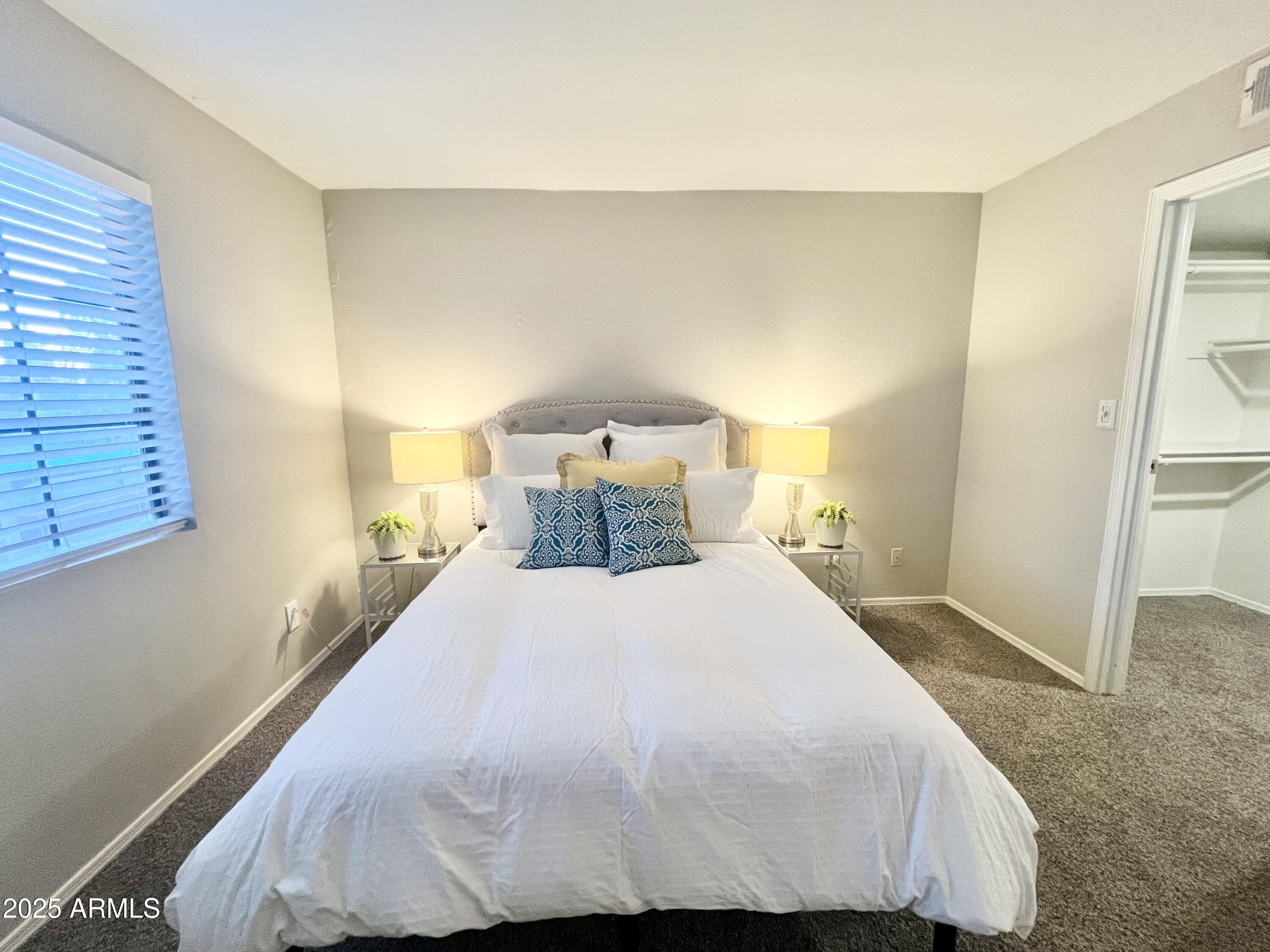 2855 South Ext Road, Unit 220 Mesa, AZ 85210 - Photo 24 of 40 a bedroom with a bed and wooden floor