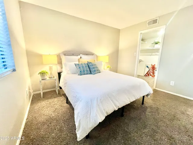 a bedroom with a bed and a night stand