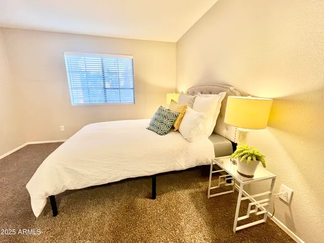 a bedroom with a bed and a table in it