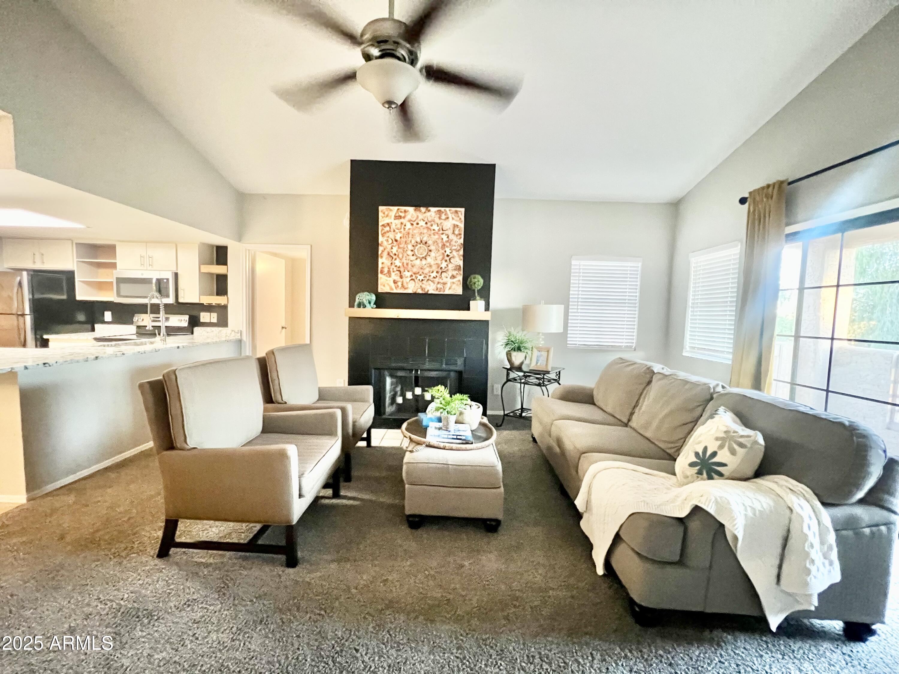 2855 South Ext Road, Unit 220 Mesa, AZ 85210 - Photo 3 of 40 a living room with furniture and a window