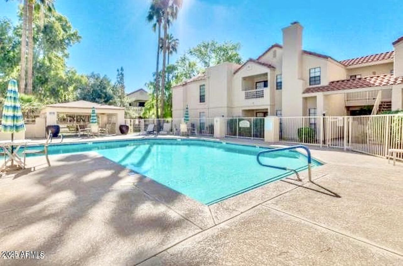 2855 South Ext Road, Unit 220 Mesa, AZ 85210 - Photo 34 of 40 a view of a house with a swimming pool