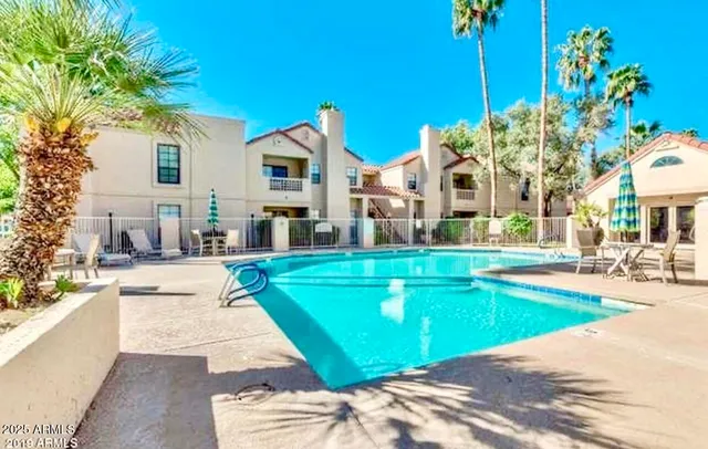a swimming pool with outdoor seating and yard