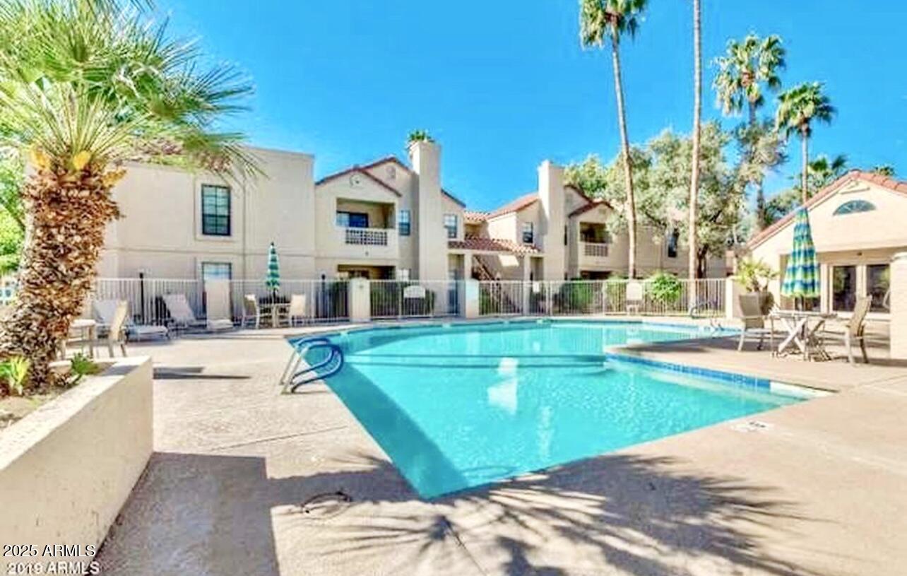 2855 South Ext Road, Unit 220 Mesa, AZ 85210 - Photo 35 of 40 a swimming pool with outdoor seating and yard