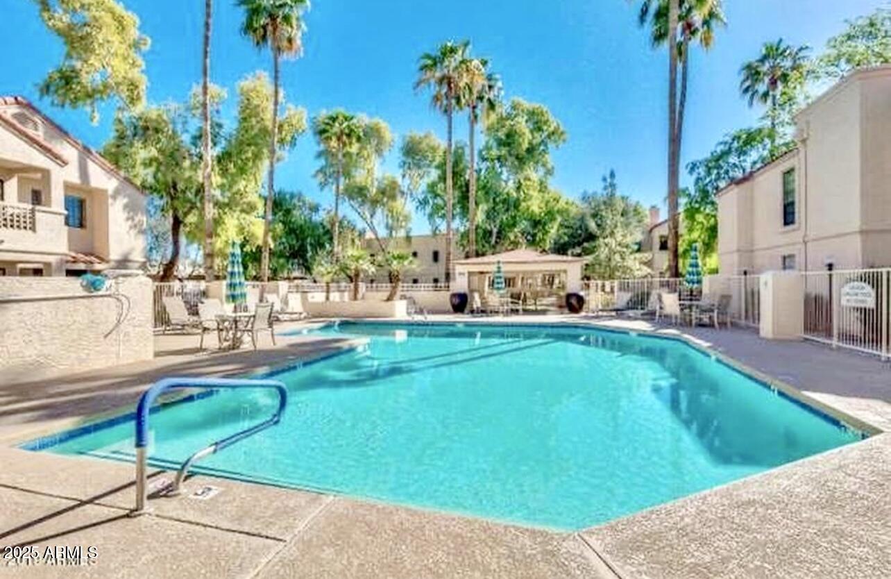 2855 South Ext Road, Unit 220 Mesa, AZ 85210 - Photo 37 of 40 a view of a swimming pool with a lounge chairs