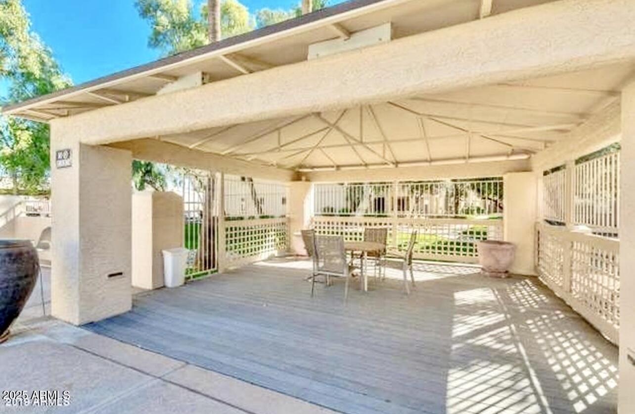 2855 South Ext Road, Unit 220 Mesa, AZ 85210 - Photo 39 of 40 a dining room with wooden floor and outdoor space