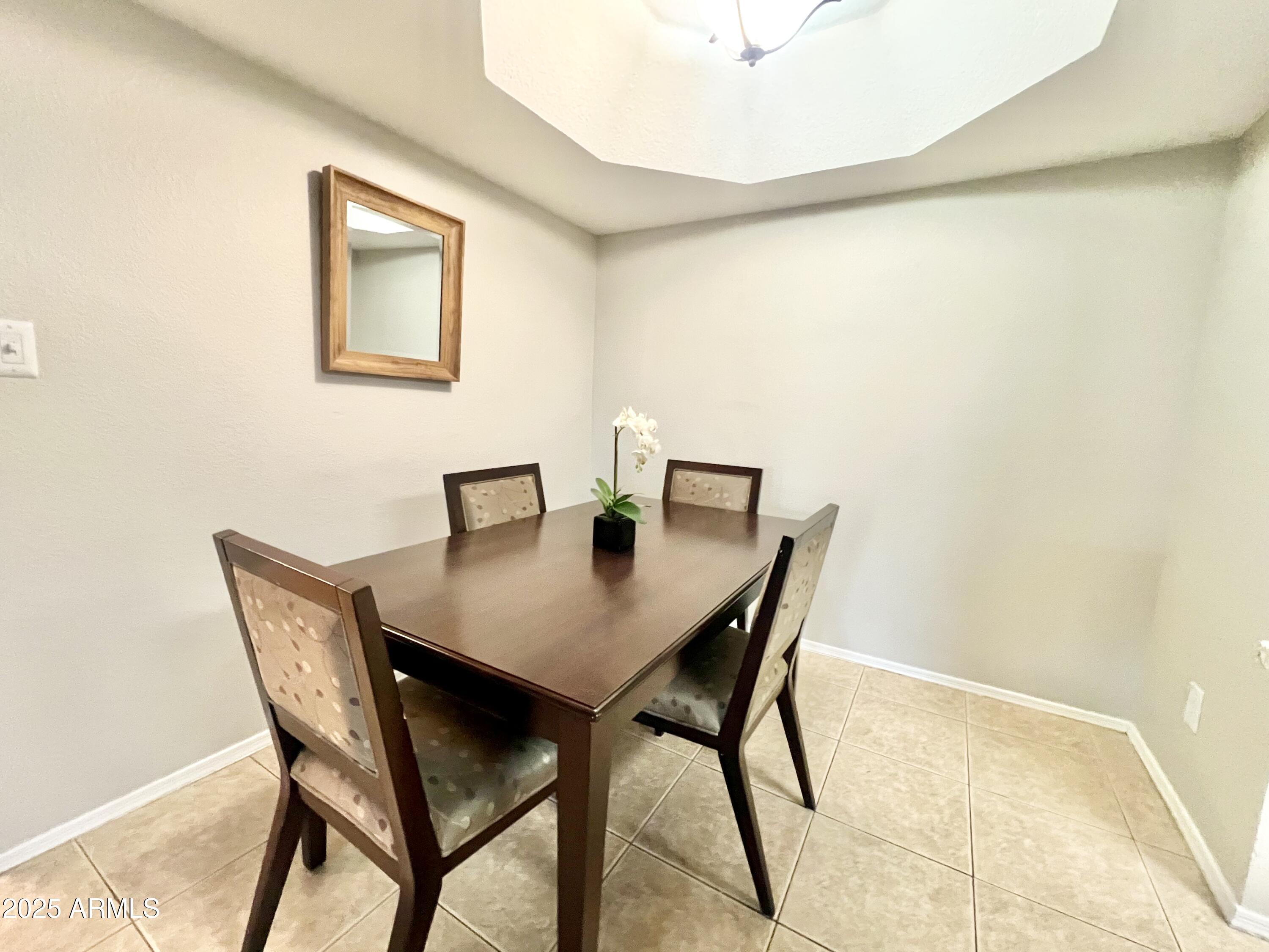 2855 South Ext Road, Unit 220 Mesa, AZ 85210 - Photo 10 of 40 a view of a dining room with furniture and a table