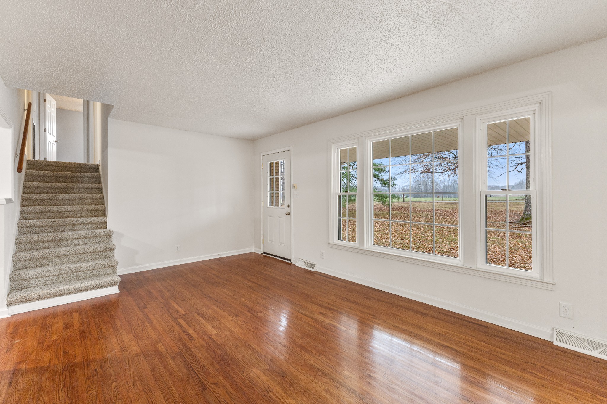 698 Houston Fielder Road Clarksville, TN 37043 - Photo 13 of 61 a view of an empty room with wooden floor and a window
