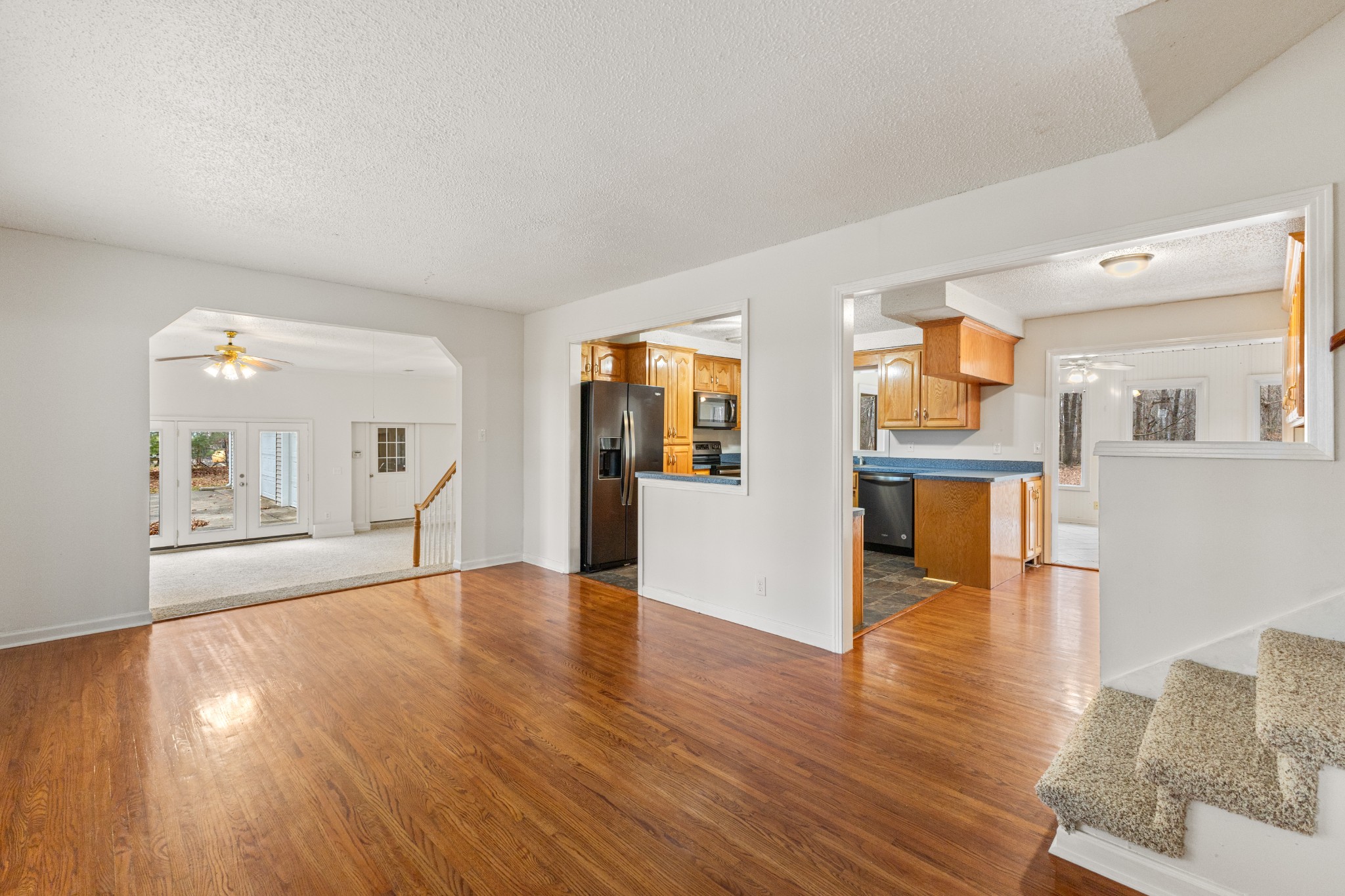698 Houston Fielder Road Clarksville, TN 37043 - Photo 14 of 61 a view of an empty room with wooden floor and a kitchen