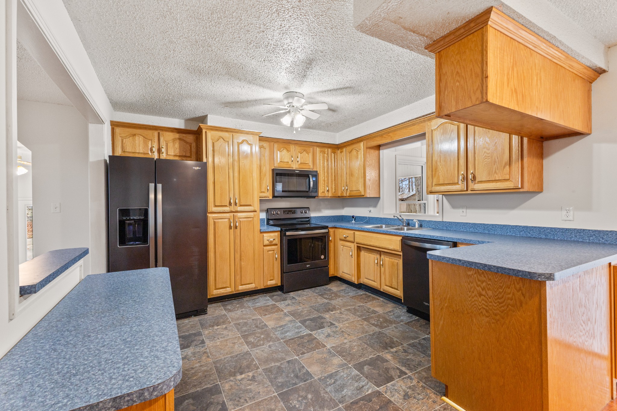 698 Houston Fielder Road Clarksville, TN 37043 - Photo 16 of 61 a kitchen with stainless steel appliances granite countertop a refrigerator a sink dishwasher a stove with wooden cabinets and floor