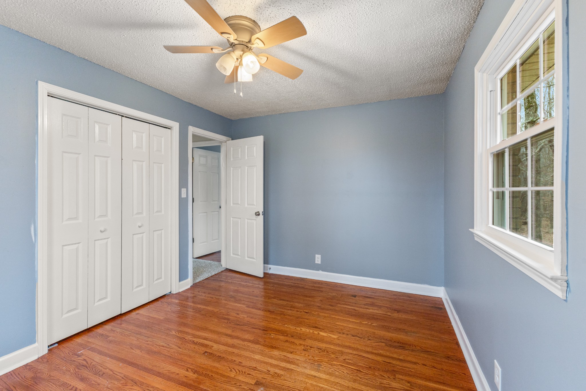 698 Houston Fielder Road Clarksville, TN 37043 - Photo 26 of 61 a view of an empty room with wooden floor and a window