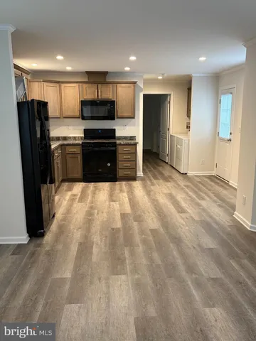 a large kitchen with a stove a refrigerator and a sink