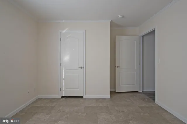 a view of an empty room and closet area