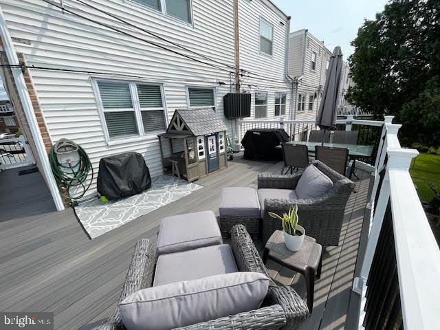 10848 Perrin Road Philadelphia, PA 19154 - Photo 30 of 38 a view of a patio with couches chairs and a dining table and chairs with wooden floor