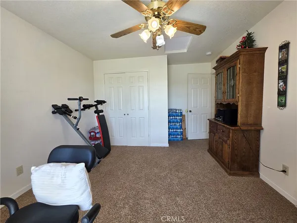 a bed sitting in a bedroom chandelier and dresser