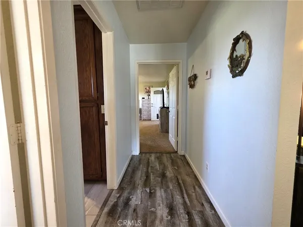 a spacious bedroom with a bed and a flat screen tv