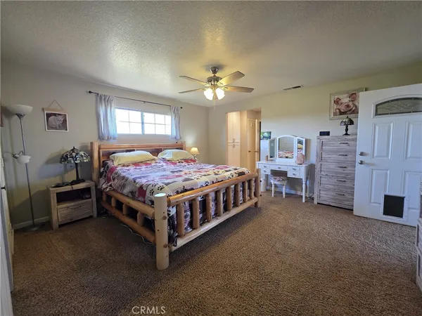 a bathroom with a granite countertop sink a toilet a mirror and bathtub