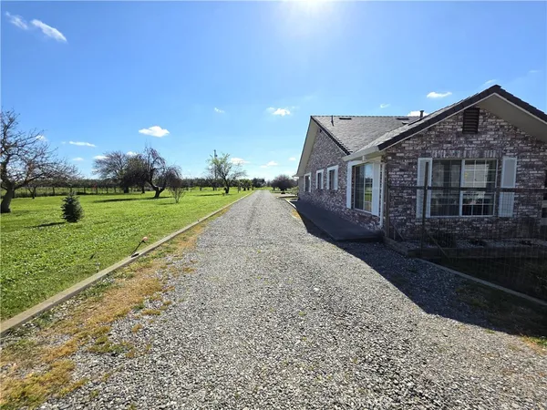 a backyard of a house with barbeque oven table and chairs