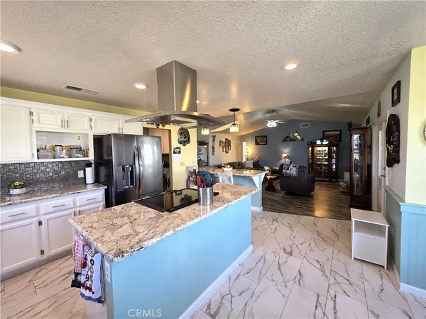 a large kitchen with a table and chairs