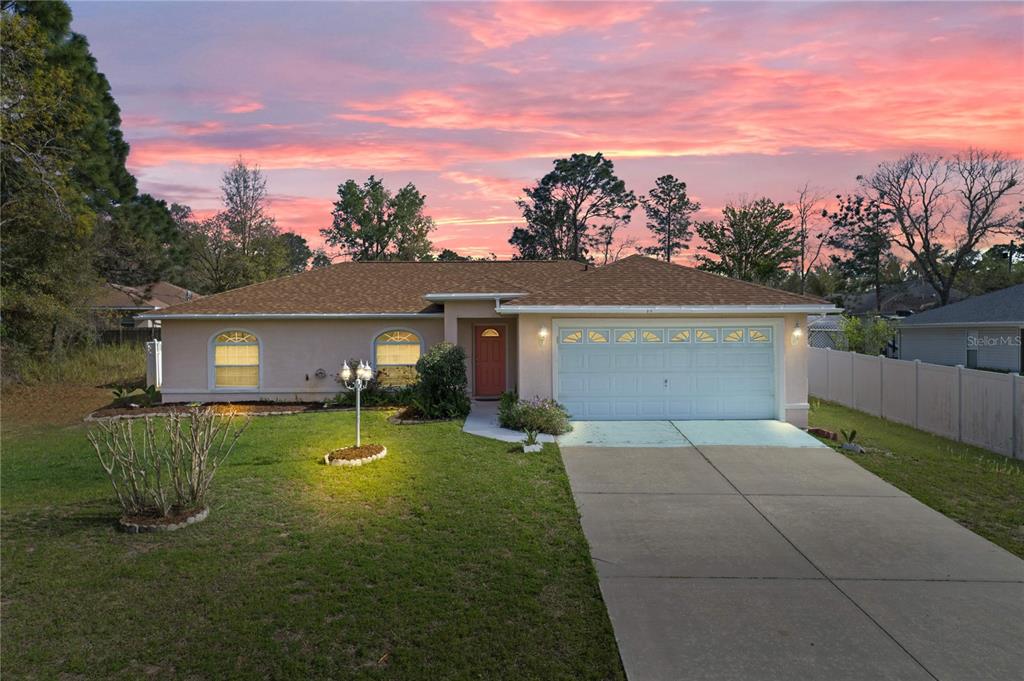 53 Hemlock Circle Ocala, FL 34472 - Photo 1 of 1 a front view of a house with a yard and trees