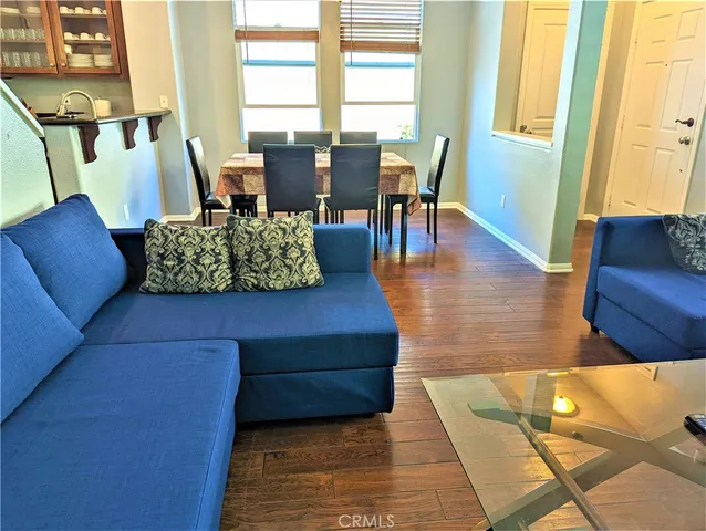 a living room with furniture rug and wooden floor