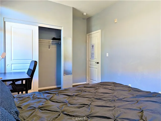 a bedroom with a bed and chair