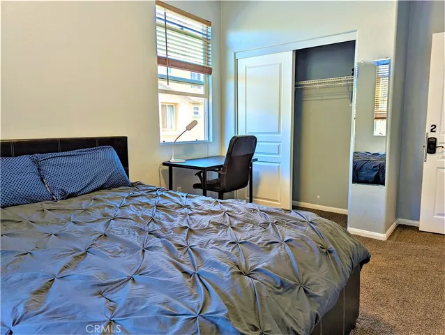 a bedroom with a bed and a chair