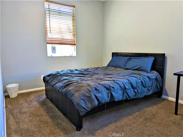 a bedroom with a bed and a chair