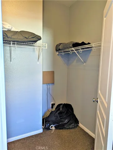 a bedroom with bed and a window