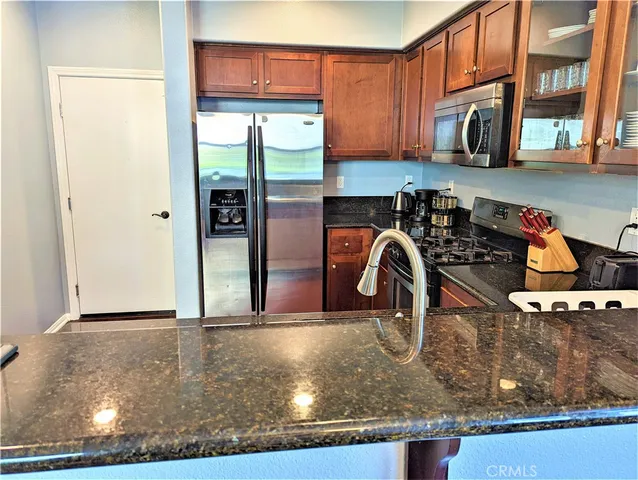a kitchen with a refrigerator and a sink