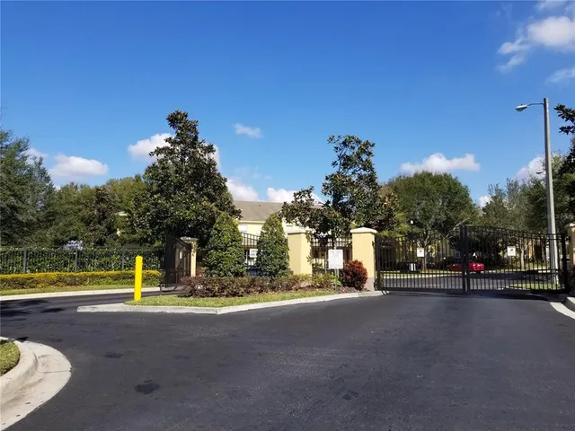 a view of a white house with a yard and plants