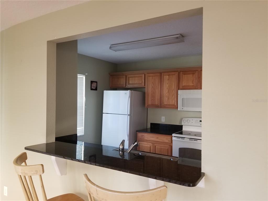 219 Drawbridge Lane Valrico, FL 33594 - Photo 8 of 24 a living room with furniture and a refrigerator
