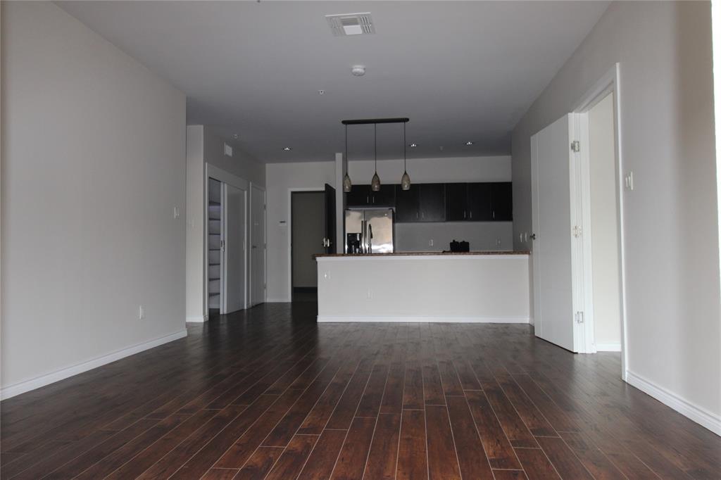 1100 West Trinity Mills Road, Unit 3035 Carrollton, TX 75006 - Photo 9 of 12 a view of cabinets and wooden floor