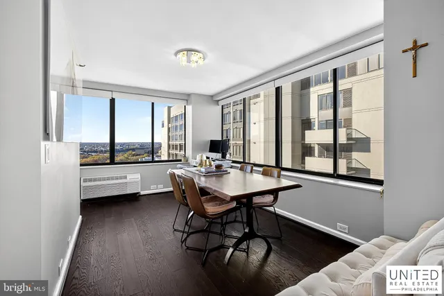 a view of a workspace with furniture and window
