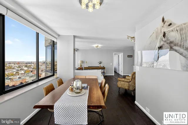 a dining room with furniture and a floor to ceiling window
