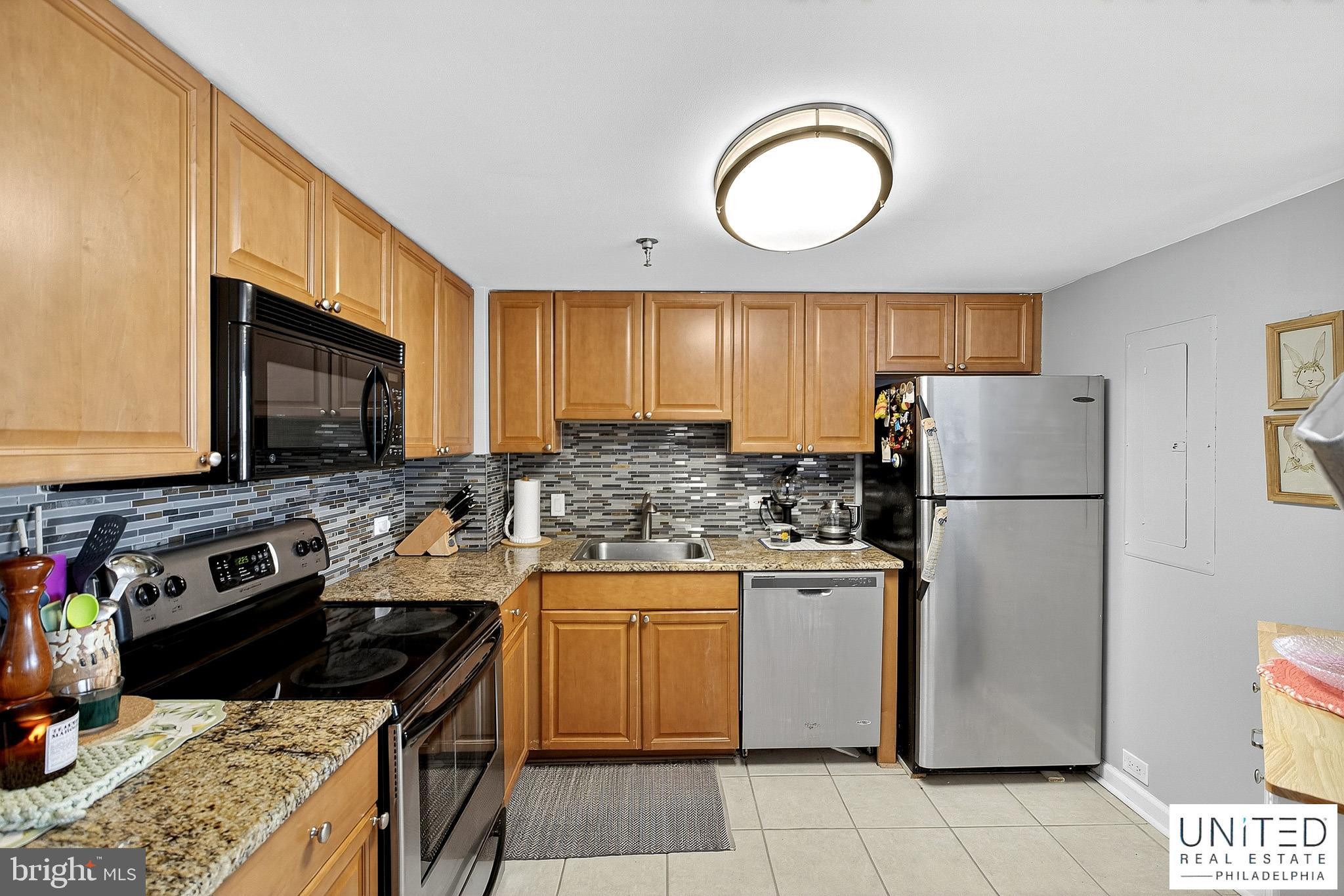 2001 Hamilton Street, Unit 2001 Philadelphia, PA 19130 - Photo 21 of 46 a kitchen with a stove a sink and a refrigerator