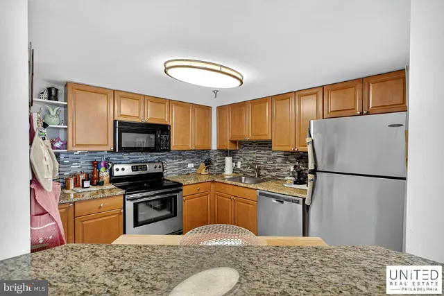 a kitchen with a sink stove and refrigerator