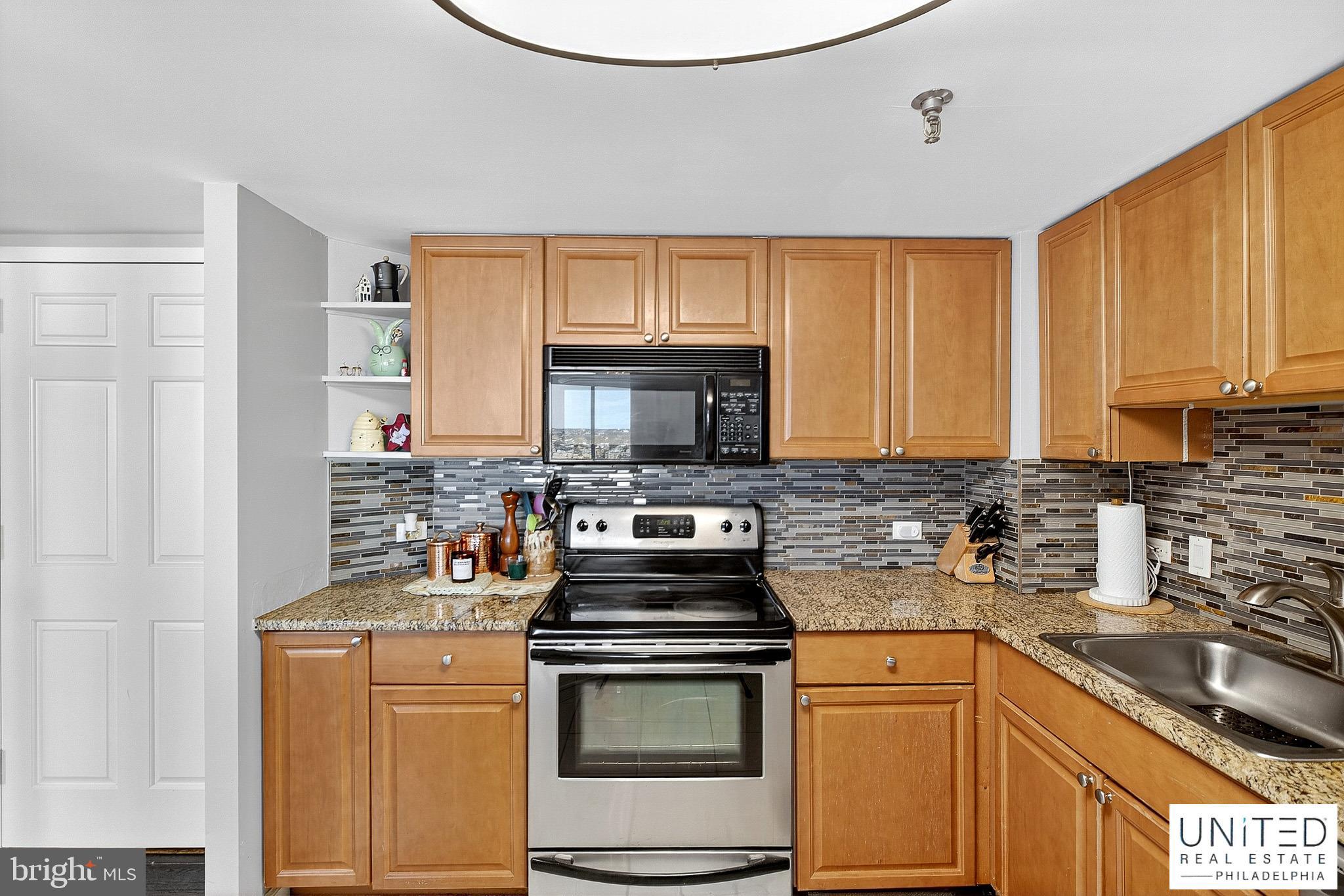 2001 Hamilton Street, Unit 2001 Philadelphia, PA 19130 - Photo 23 of 46 a kitchen with stainless steel appliances a stove a sink a microwave and cabinets