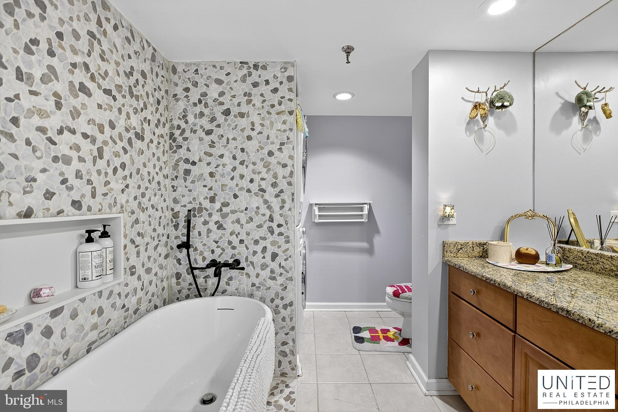 2001 Hamilton Street, Unit 2001 Philadelphia, PA 19130 - Photo 24 of 46 a bathroom with a bathtub sink vanity and shower
