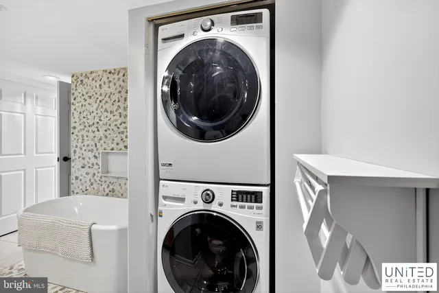 a view of a hallway with washer and dryer