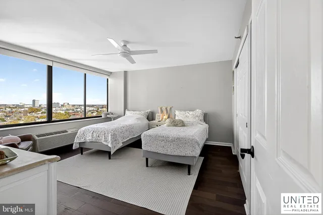 a living room with bed furniture and large window