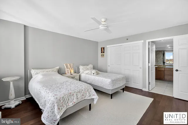 a bedroom with two beds and painted walls