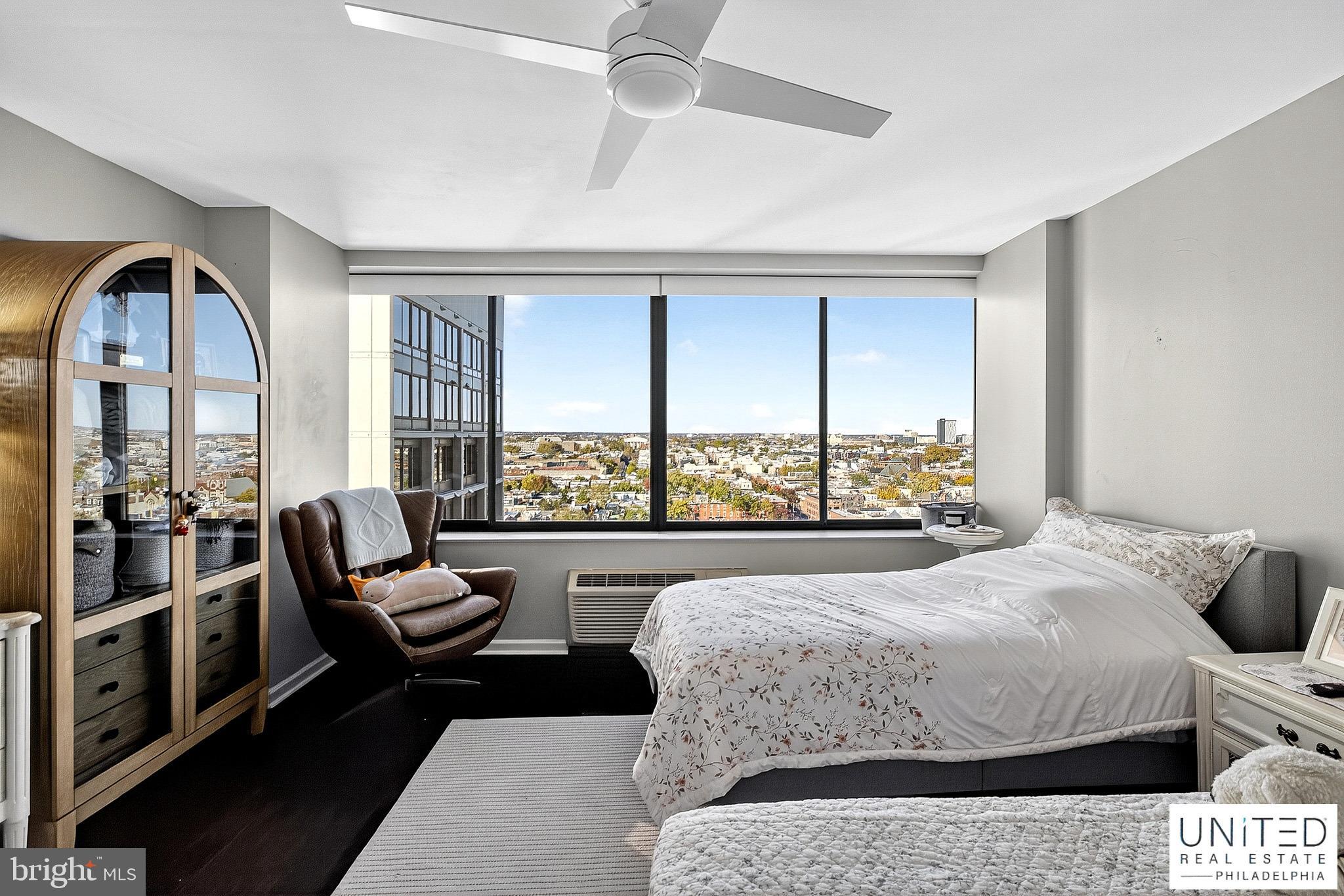 2001 Hamilton Street, Unit 2001 Philadelphia, PA 19130 - Photo 36 of 46 a living room with a bed furniture and a large window