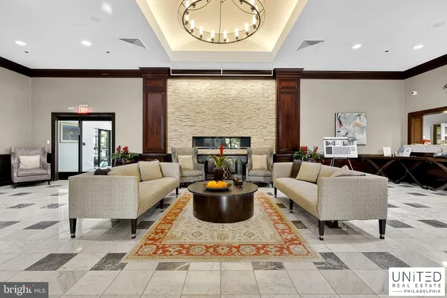 a living room with fireplace furniture and a large window