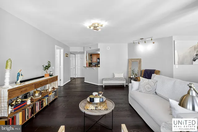 a living room with furniture and a chandelier
