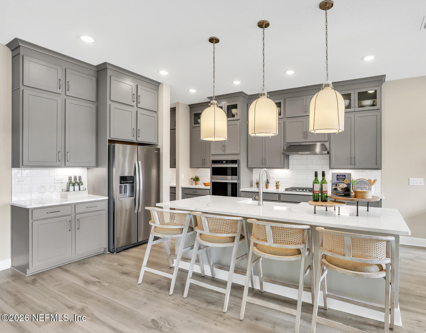 60 Ribera Drive Flagler Beach, FL 32136 - Photo 12 of 26 a kitchen with stainless steel appliances granite countertop a sink a stove a refrigerator cabinets and chairs