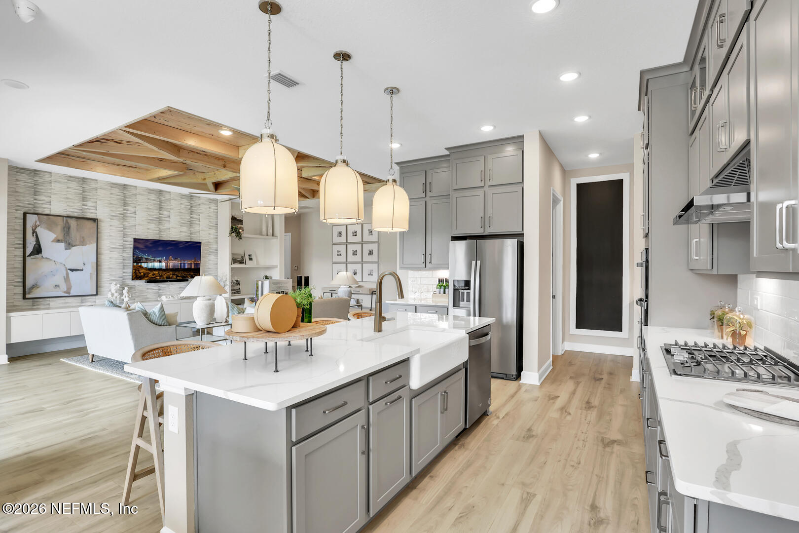 60 Ribera Drive Flagler Beach, FL 32136 - Photo 17 of 26 a kitchen with stainless steel appliances kitchen island granite countertop a sink a stove a refrigerator and island with wooden floor