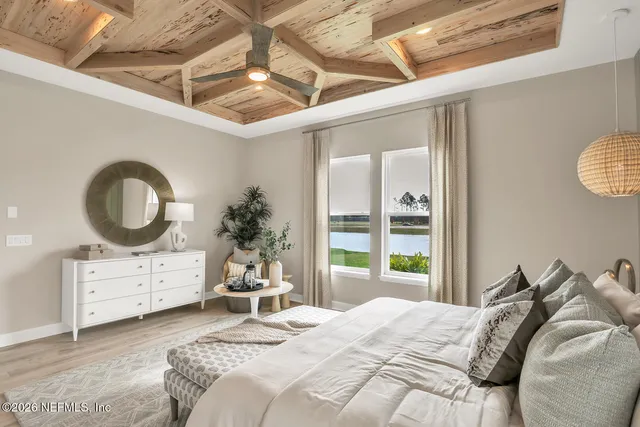 a bedroom with a bed a dresser and mirror