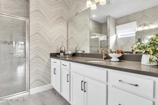 a bathroom with a sink a mirror and a shower