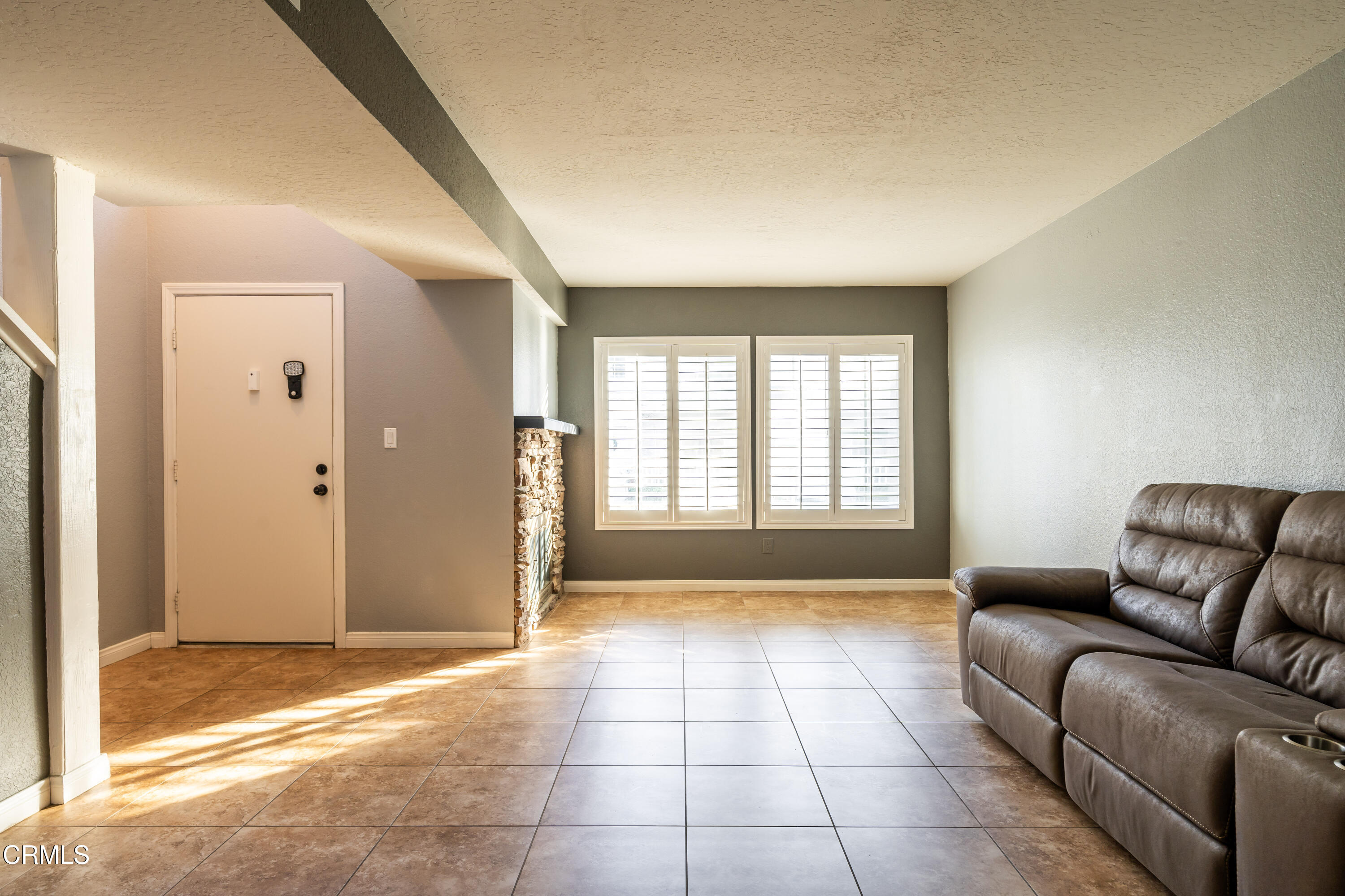186 West Walnut Avenue, Unit E Rialto, CA 92376 - Photo 5 of 22 a living room with a couch and a rug